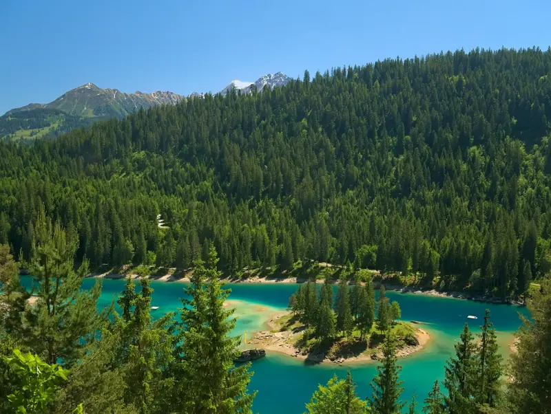 Best lakes in Switzerland for swimming: the turquoise Caumasee in the forest below Flims