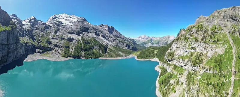 Turquoise Oeschinensee lake below the Blüemlisalp cliffs above Kandersteg
