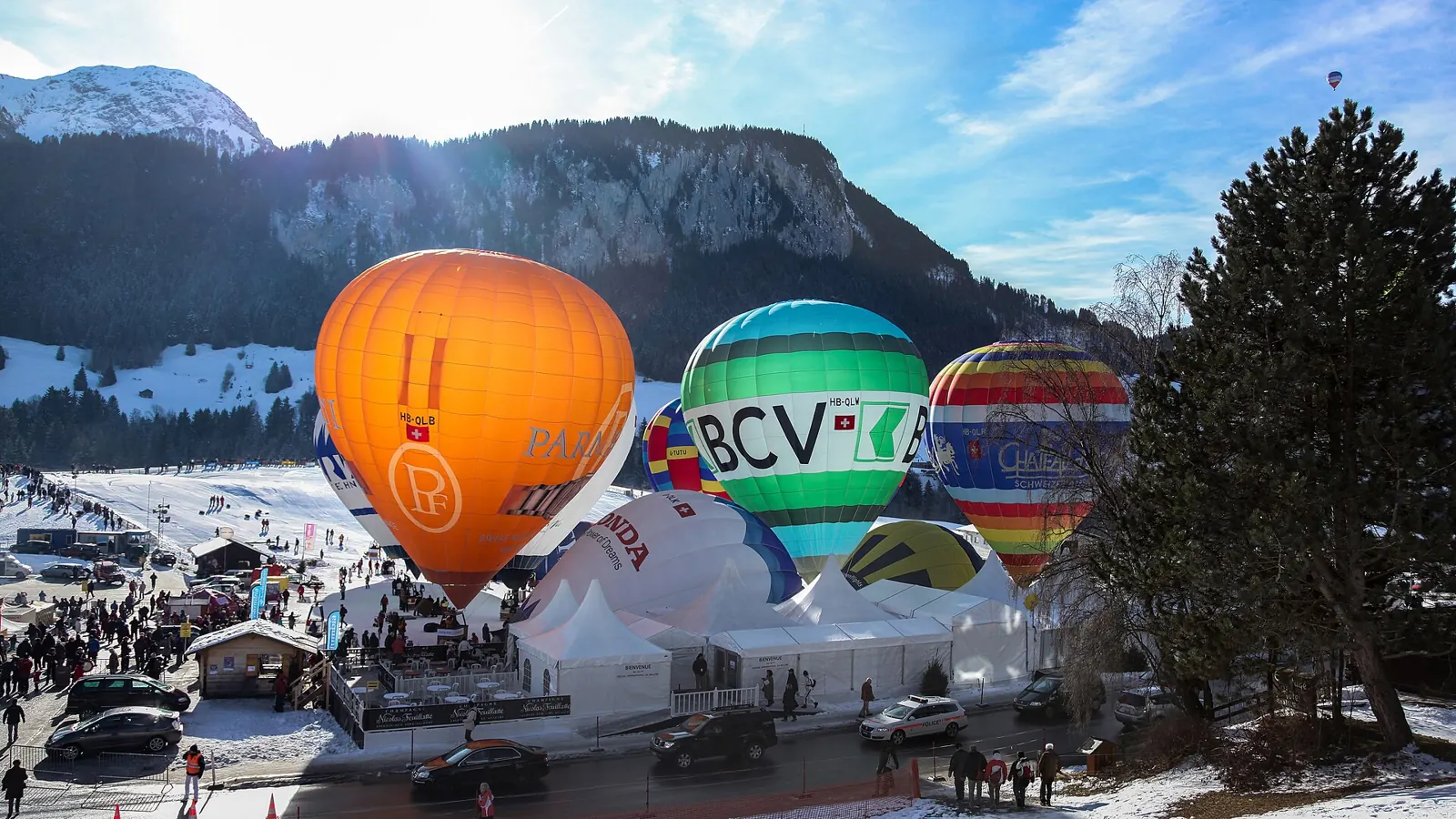 Hot-air balloons over the snowy Pays-d'Enhaut at the Château-d'Oex balloon festival in January
